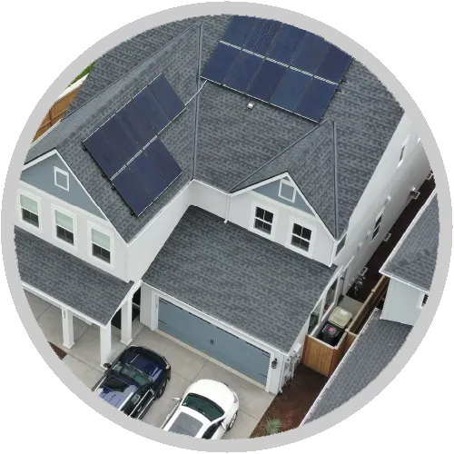 An aerial view of a house with solar panels on the roof