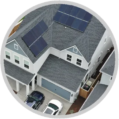 An aerial view of a house with solar panels on the roof