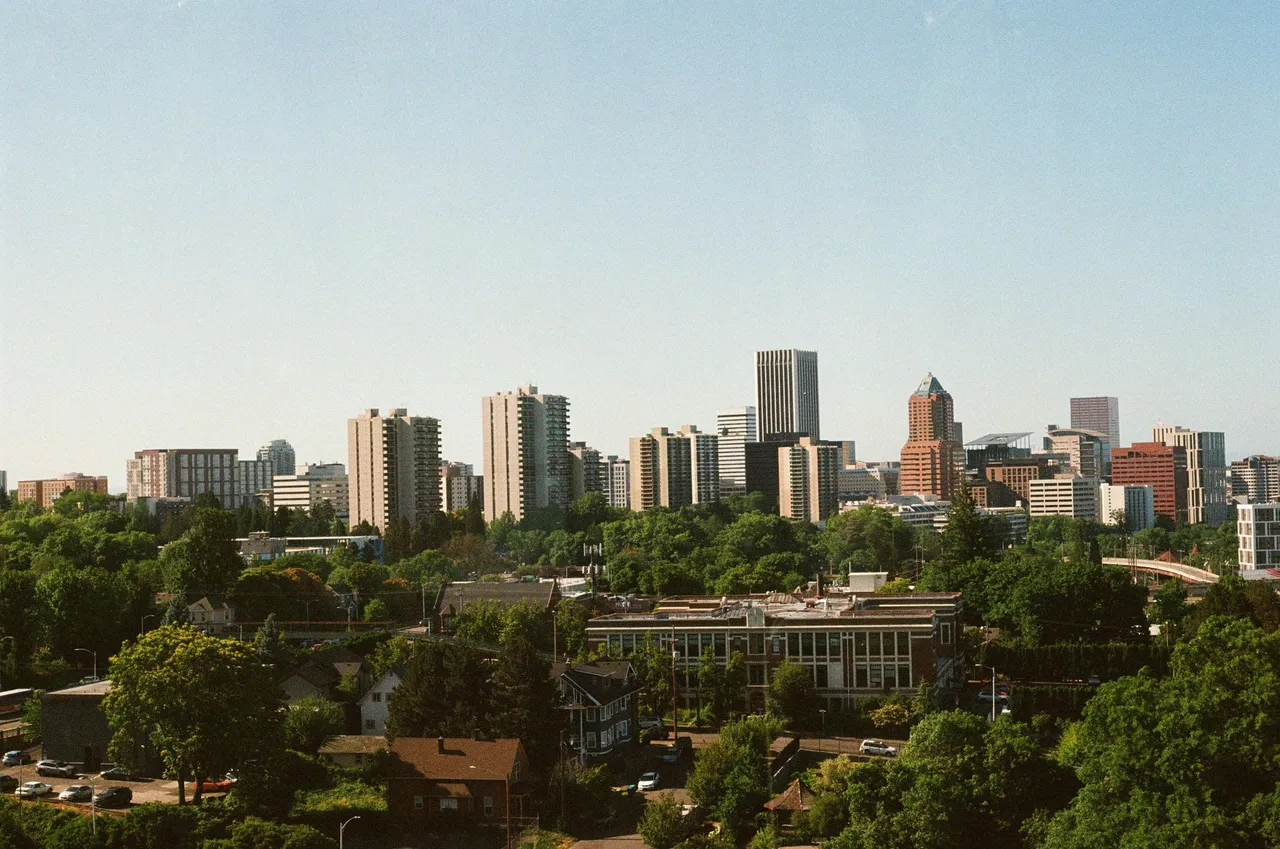 The skyline of New Jersey is reflected in a lake.