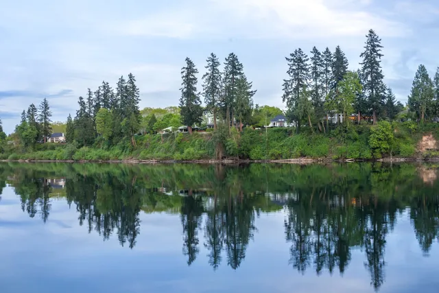 The skyline of New Jersey is reflected in a lake.